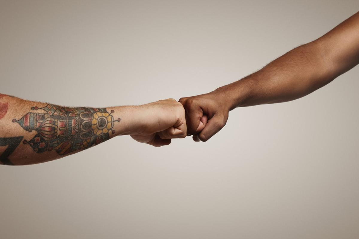 Peers supporting each other with a fist bump