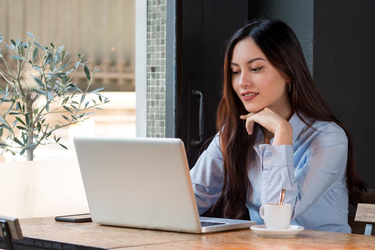 Woman looking at laptop screen at desk